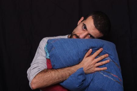 sleepy man with his pillowの写真素材