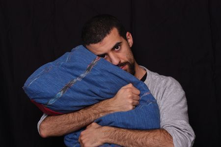 sleepy man with his pillowの写真素材