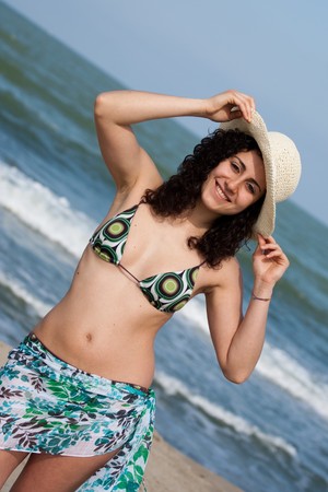 young woman wearing swimsuit at the seasideの写真素材