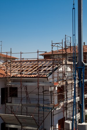 Scaffold and a the Broken Roof of an Houseの写真素材