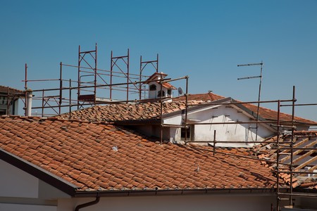 Scaffold and a the Broken Roof of an Houseの写真素材