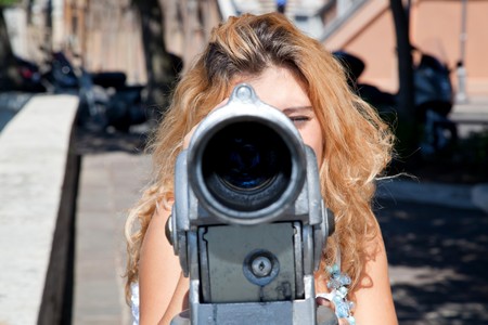 Smiling Blonde Girl Looking Trough Telescope with Surprised Face