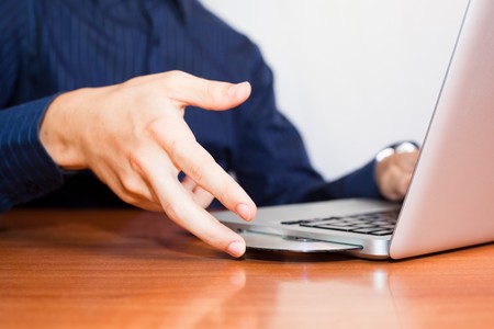 Man Insert a CD into Computer