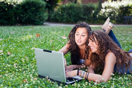 Two Young Woman With Laptop PC at Parkの写真素材
