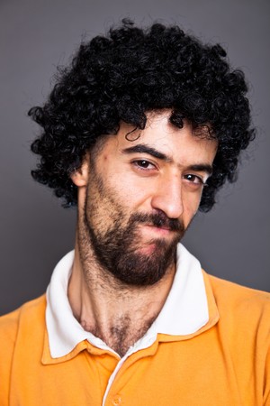 Young Man with Wig Making a Faceの写真素材