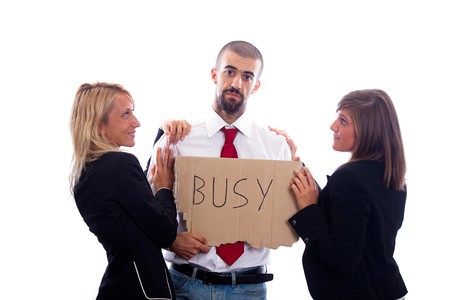Businessman Hold Busy Sign with Two Businesswoman Flirtingの写真素材
