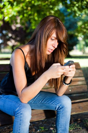 Young Woman Typing on the Phoneの写真素材