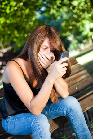 Young Woman Typing on the Phoneの写真素材