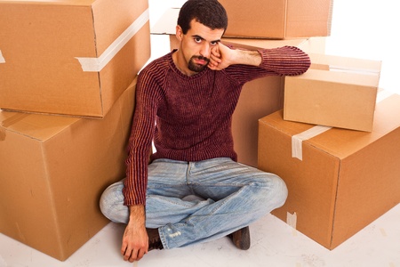 Stressed Young Man on Moving Swamped with Boxes