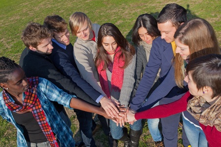 Happy College Students with Hands on Stack 