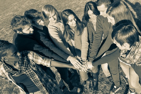 Happy College Students with Hands on Stack の写真素材