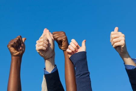 Multiracial Thumbs Up Against Blue Skyの写真素材