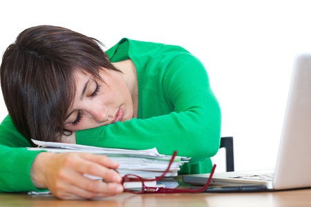 Tired Young Woman Sleeping at Workの写真素材