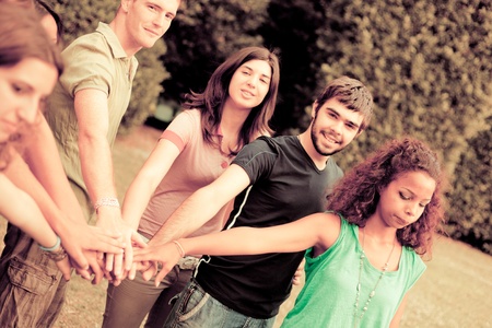 Happy Teenage Group with Hands on Stack