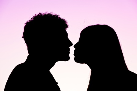 Young Couple Silhouette at Sunsetの写真素材