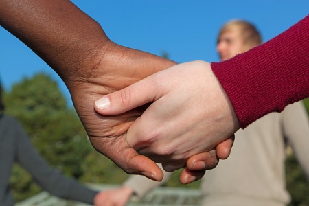 Multiracial Young People Holding Hands in a Circleの写真素材