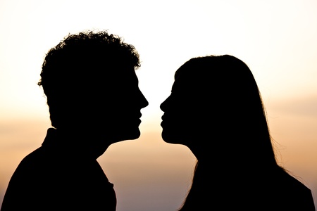Young Couple Silhouette at Sunsetの写真素材