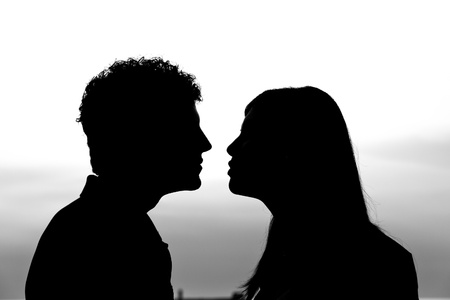 Young Couple Silhouette at Sunsetの写真素材