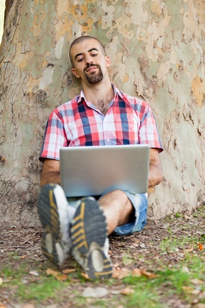 Young Man With Computer at Parkの写真素材