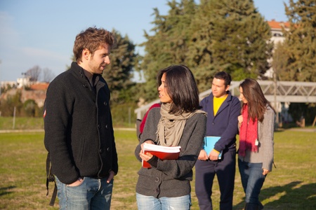 College Students Walking and Talking at Parkの写真素材