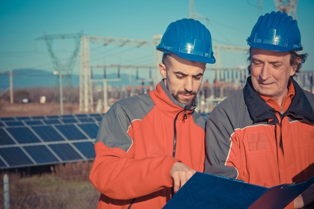 Engineers at Work In a Solar Power Stationの写真素材