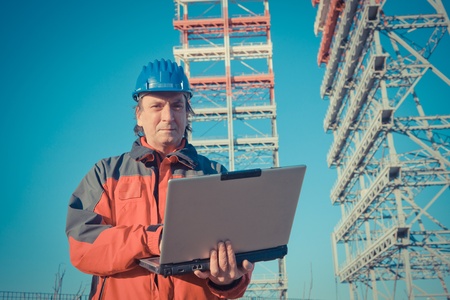 Engineer with Computer in Construction Siteの写真素材