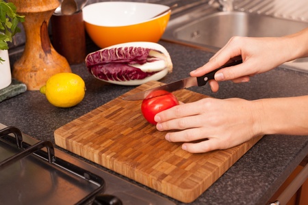 Woman Cutting Tomatoの写真素材