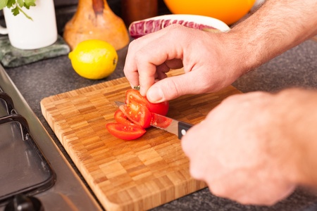 Man Cutting Tomatoの写真素材