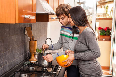 Happy Multiracial Couple in the Kitchenの写真素材
