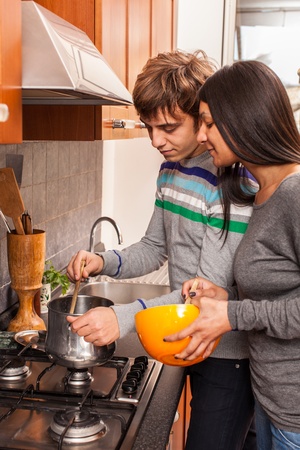 Happy Multiracial Couple in the Kitchenの写真素材