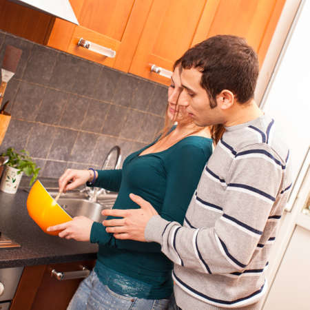 Wife and Husband Cooking Together in the Kitchenの写真素材