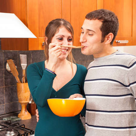 Woman Giving Her Husband a Tasteの写真素材