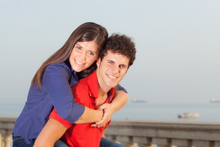 Smiling Young Couple Piggybackingの写真素材