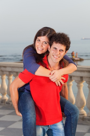 Smiling Young Couple Piggybackingの写真素材