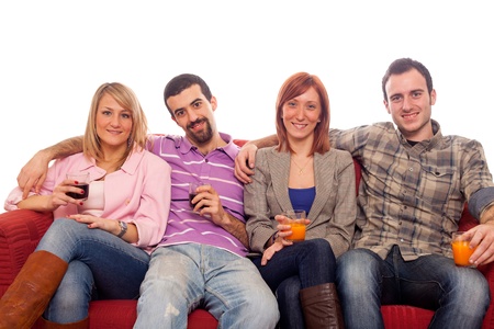 Young Group Sitting on Sofa and Drinkingの写真素材