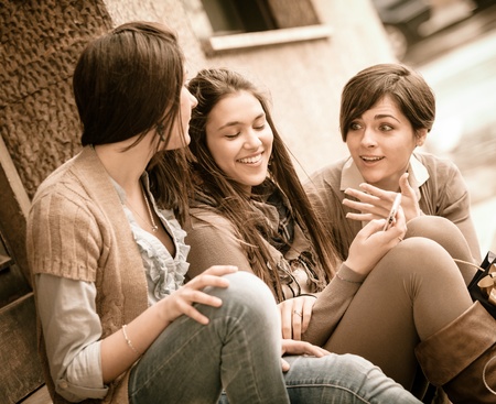 Group of Women Sending Message with Mobile Phoneの写真素材