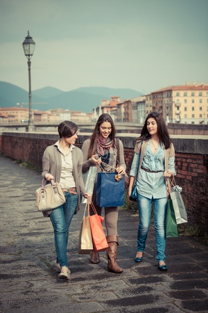 Beautiful Young Women Waliking in the City with Shopping Bagsの写真素材
