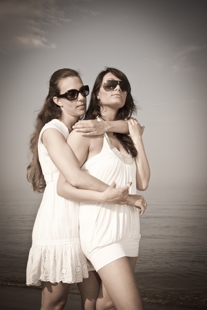 Two Female Friends Embraced on the Beachの写真素材