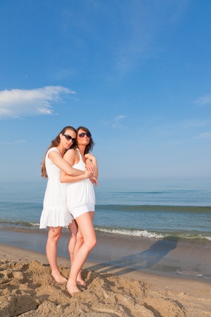 Two Female Friends Embraced on the Beachの写真素材