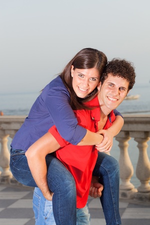 Smiling Young Couple Piggybackingの写真素材