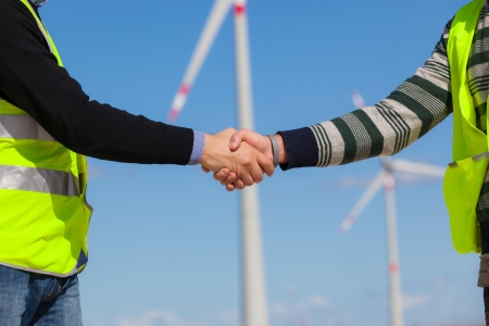 Engineers giving Handshake in a Wind Turbine Power Stationの写真素材