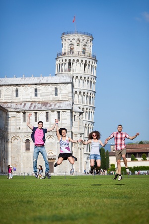 Group of Friends Jumping with Pisa Leaning Tower on Backgroundの写真素材