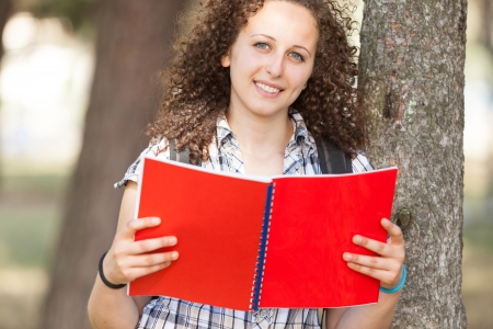 Young Beautiful Female Student at Parkの写真素材