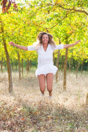 Beautiful Young Woman Jumping Outdoorの写真素材