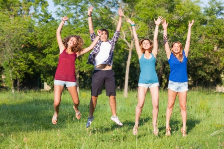 Group of Teenagers Jumping at Parkの写真素材