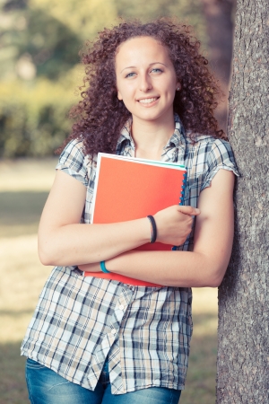 Young Beautiful Female Student at Parkの写真素材
