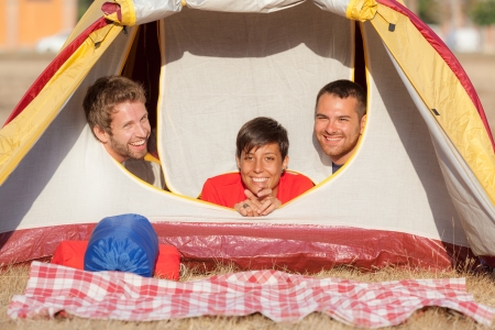 Three Friends Camping Inside the Tentの写真素材