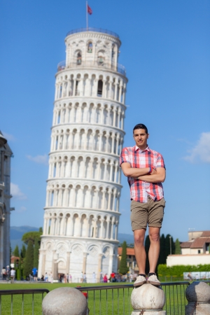 Young Boy Posing with Leaning Tower in Pisaの写真素材