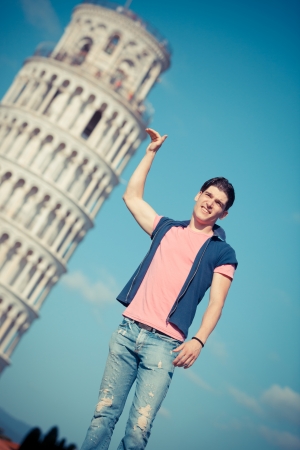Young Man Posing with Leaning Tower in Pisaの写真素材