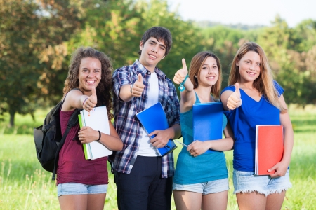 Teenage Students with Thumbs upの写真素材